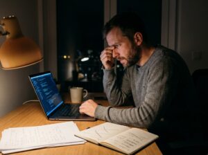 Candidate works late on a Toptal test project, marking up notes at his desk